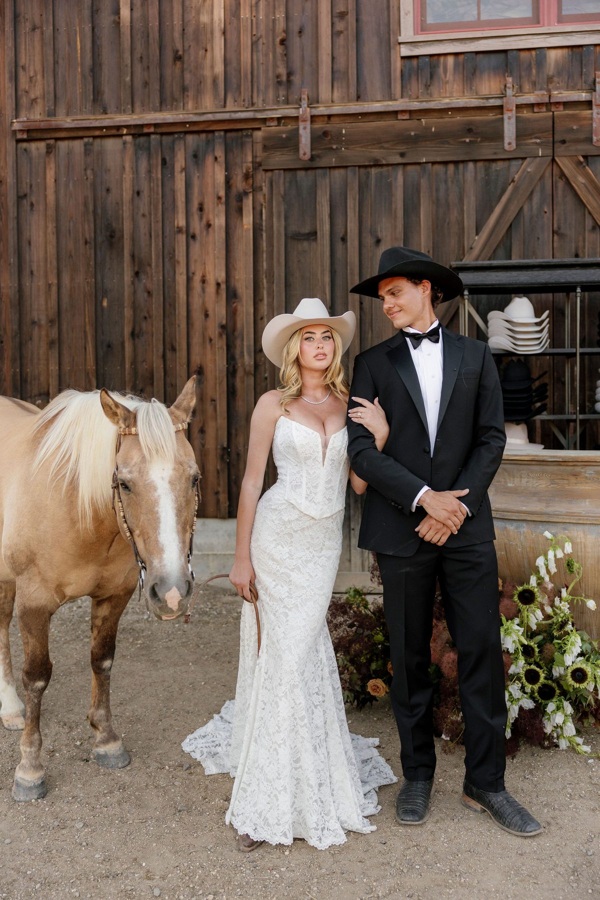 The couple and a palomino at the barn hat bar