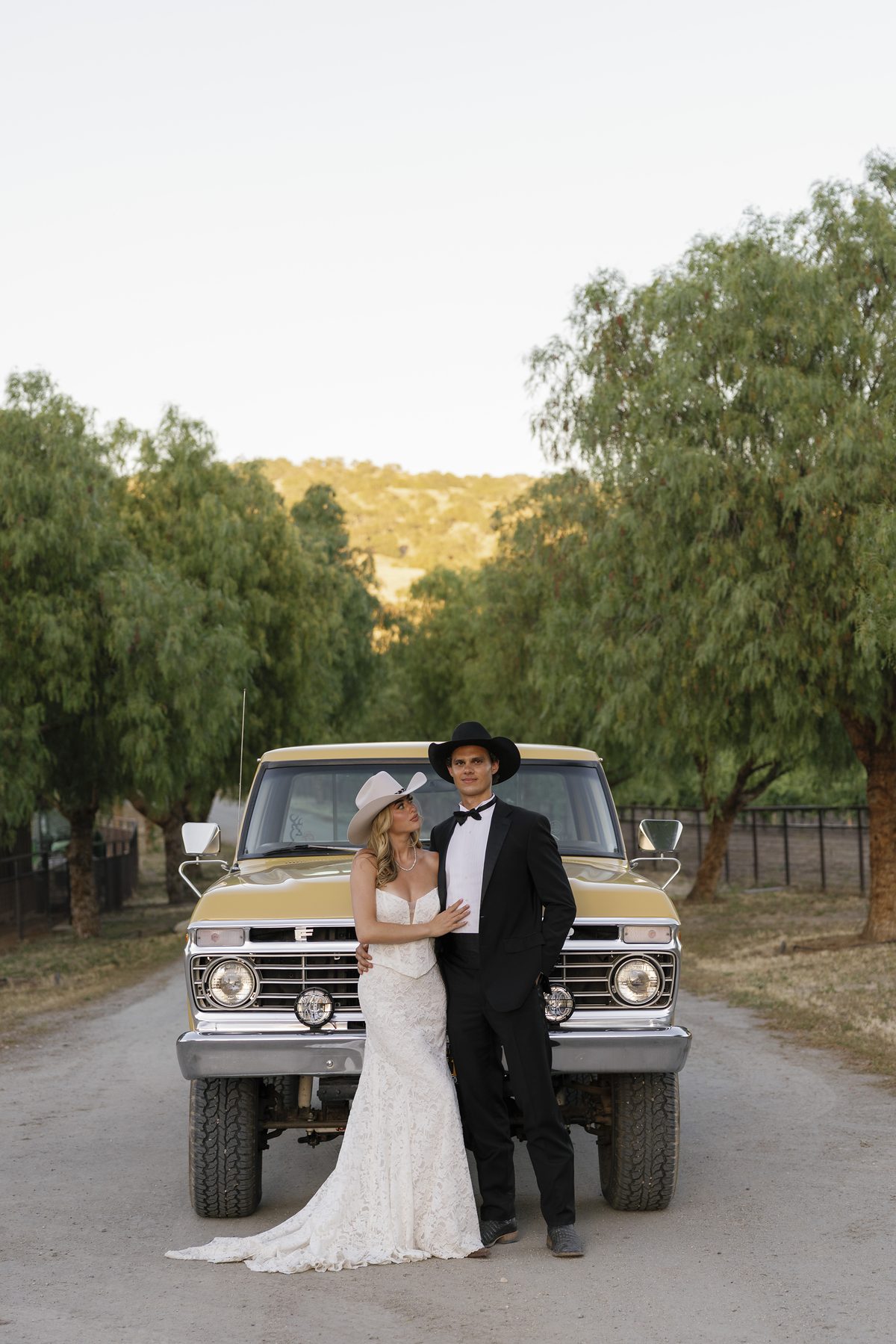 The couple with a vintage pickup on the ranch drive