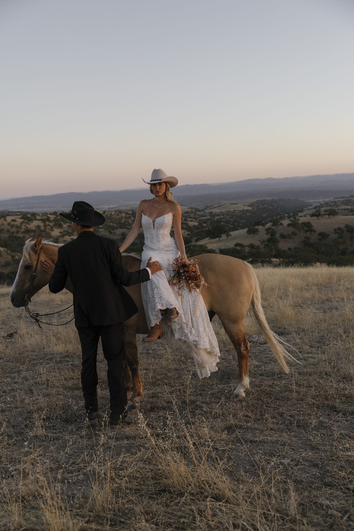 The couple with a palomino in the hills